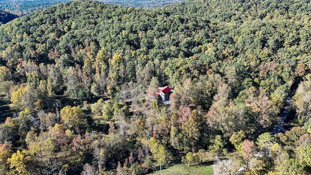 drone / aerial view featuring a forest view