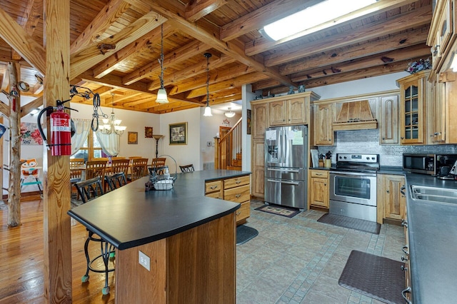kitchen featuring premium range hood, stainless steel appliances, a center island, decorative backsplash, and dark countertops