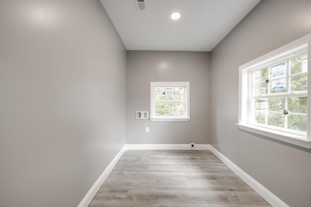 spare room with light wood-type flooring