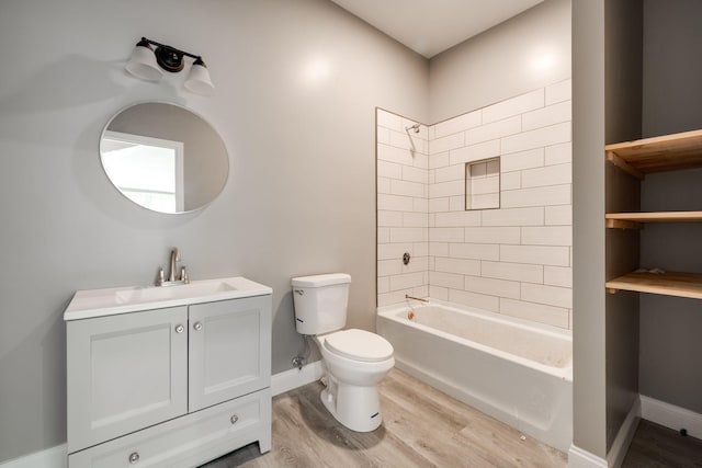 full bathroom with vanity, hardwood / wood-style flooring, toilet, and tiled shower / bath combo