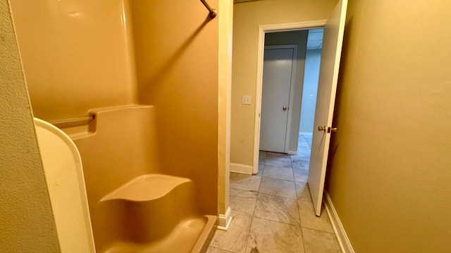 bathroom with tile patterned flooring and a shower