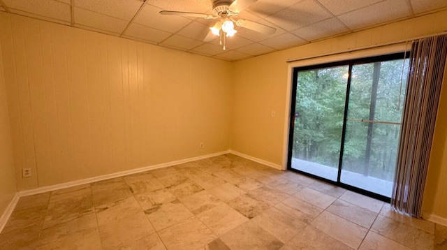 spare room featuring a paneled ceiling and ceiling fan