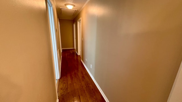 hall featuring dark hardwood / wood-style floors, ornamental molding, and a textured ceiling