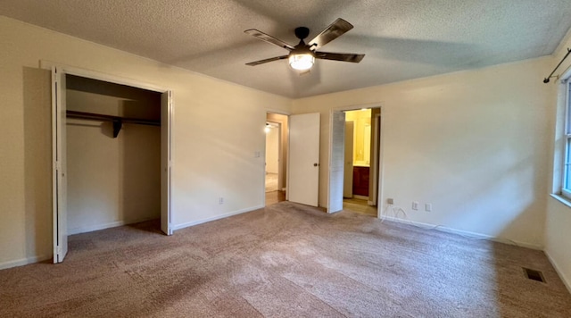 unfurnished bedroom with ceiling fan, light colored carpet, a textured ceiling, and a closet