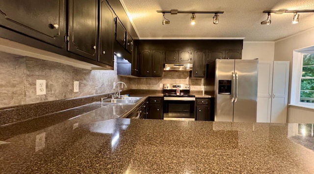 kitchen featuring a textured ceiling, sink, stainless steel appliances, and tasteful backsplash