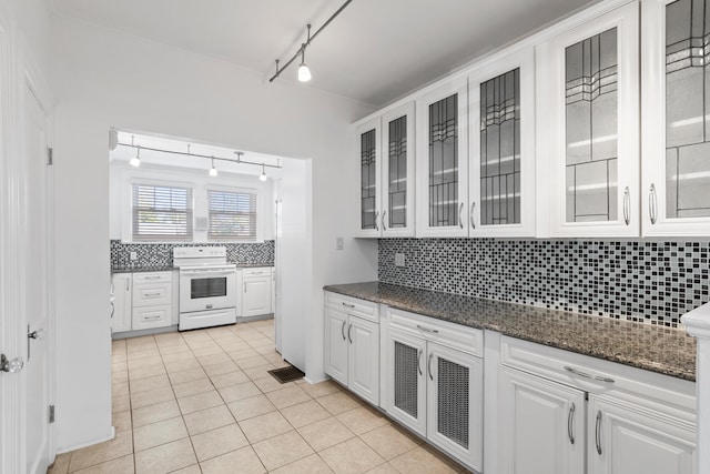 kitchen with white cabinets, decorative backsplash, electric stove, and rail lighting