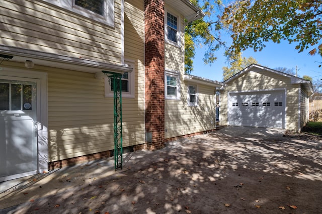 view of side of property with an outdoor structure and a garage