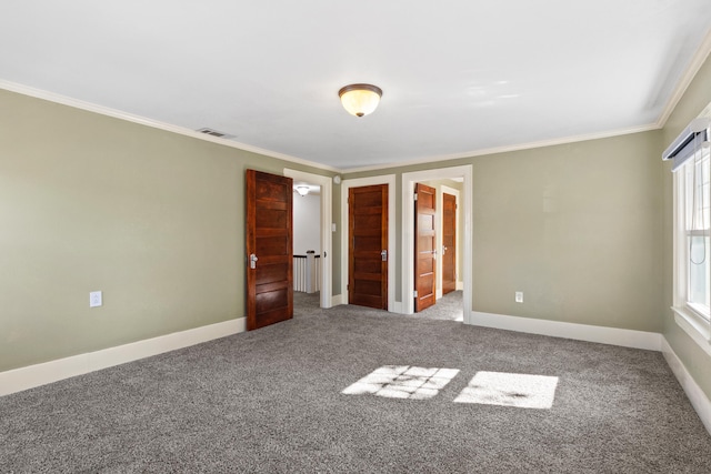 unfurnished bedroom featuring carpet flooring, ensuite bathroom, and ornamental molding