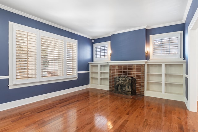 unfurnished living room featuring hardwood / wood-style floors, a healthy amount of sunlight, and crown molding