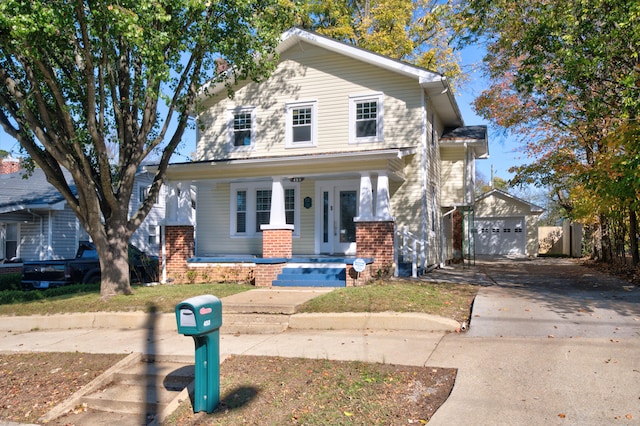 view of front facade with an outbuilding, a porch, and a garage