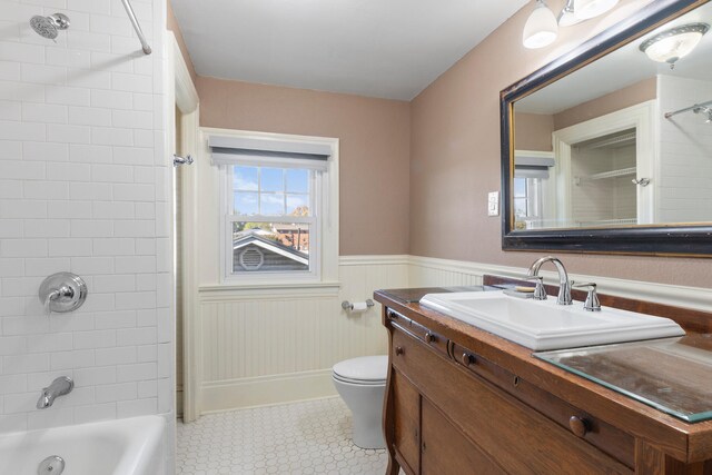 full bathroom featuring vanity, toilet, and tiled shower / bath