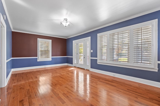 spare room with crown molding and light hardwood / wood-style flooring