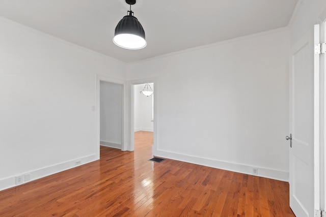 unfurnished room with hardwood / wood-style floors and ornamental molding