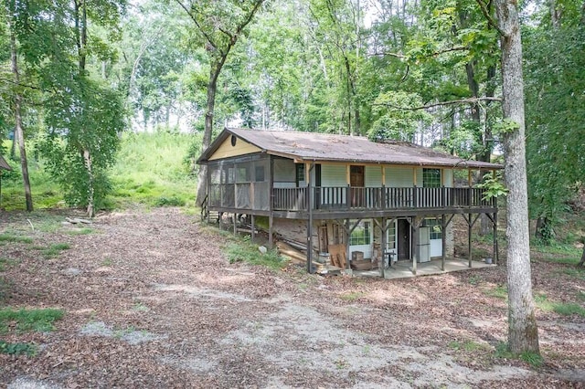 view of front of house featuring a sunroom, a patio, and a deck