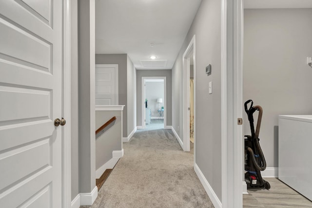corridor with baseboards, washer / clothes dryer, recessed lighting, and light colored carpet