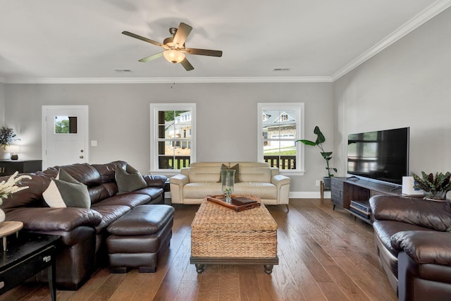 living area featuring healthy amount of natural light, a ceiling fan, hardwood / wood-style flooring, and crown molding