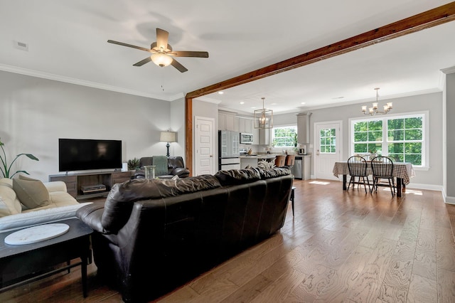 living area featuring a chandelier, wood finished floors, ornamental molding, a ceiling fan, and recessed lighting