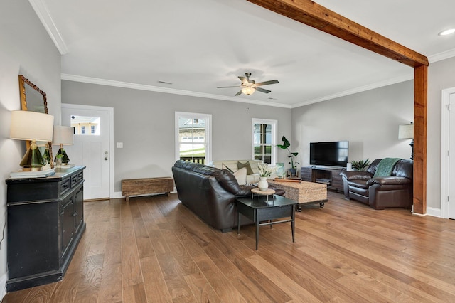 living room with hardwood / wood-style flooring, ceiling fan, crown molding, and baseboards