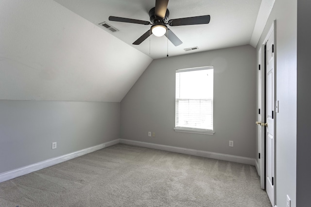 bonus room featuring lofted ceiling, carpet, visible vents, and baseboards