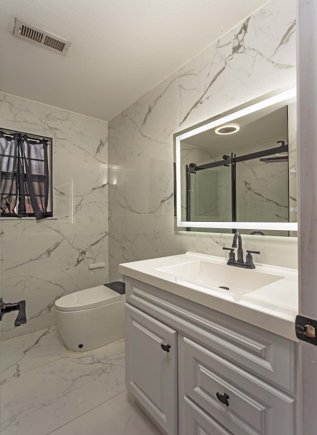 bathroom featuring visible vents, toilet, a marble finish shower, stone wall, and vanity
