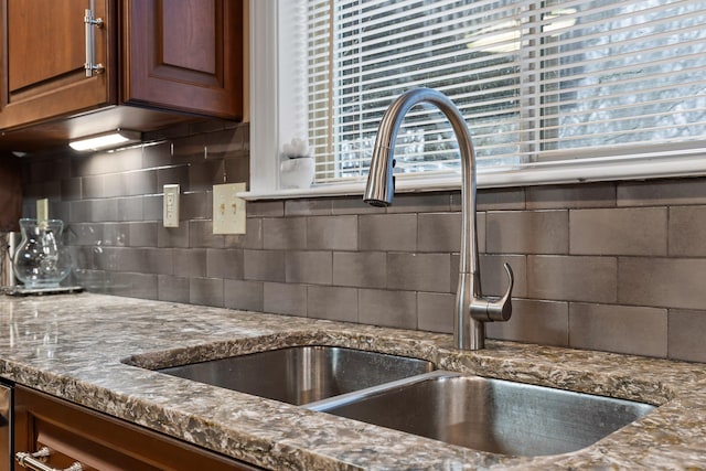 kitchen featuring sink and tasteful backsplash