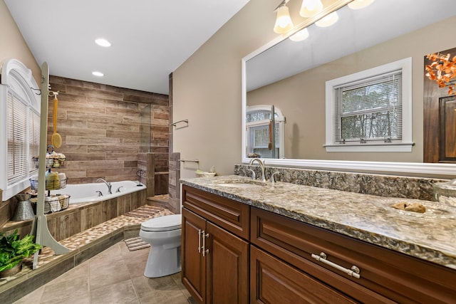 full bathroom with tile patterned flooring, vanity, toilet, and independent shower and bath