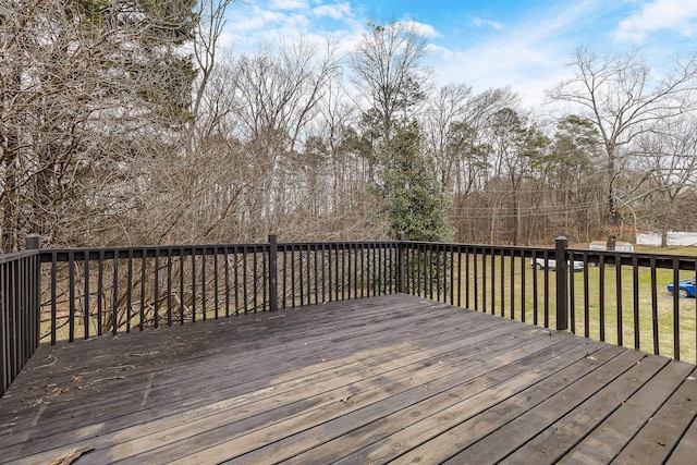 wooden deck with a lawn