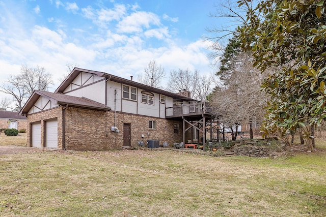 back of house featuring central AC unit, a wooden deck, and a lawn