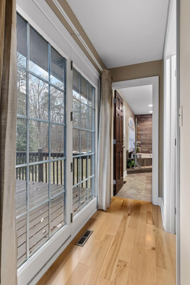 entryway featuring wood walls and light hardwood / wood-style floors