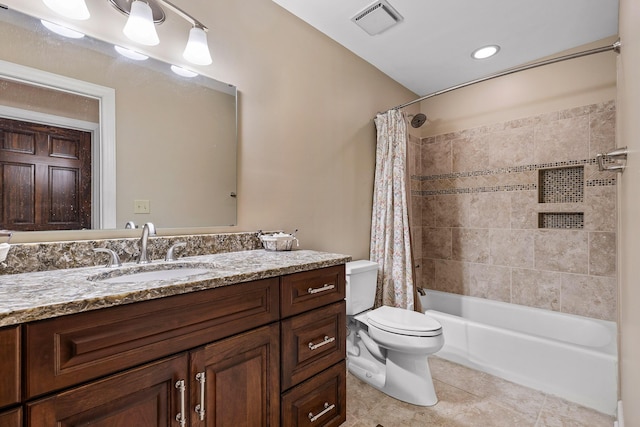 full bathroom featuring tile patterned floors, vanity, toilet, and shower / bath combo with shower curtain