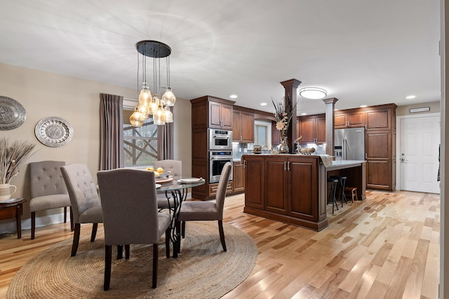 dining room featuring light hardwood / wood-style flooring and a chandelier