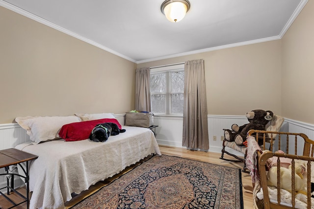 bedroom featuring hardwood / wood-style floors and ornamental molding