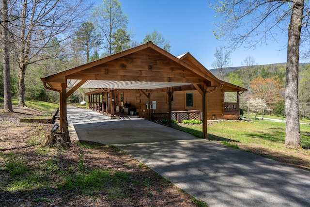 view of property's community with a yard, driveway, and a carport