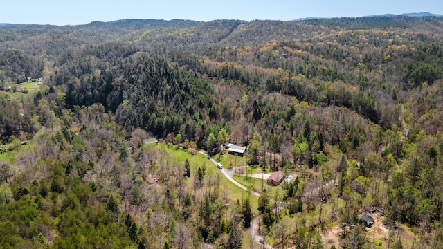 drone / aerial view with a mountain view and a wooded view