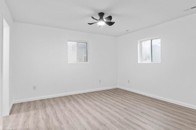 empty room with ceiling fan and light wood-type flooring