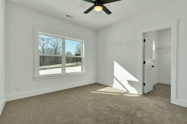 empty room featuring light colored carpet and ceiling fan