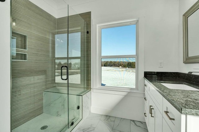 bathroom featuring walk in shower and vanity