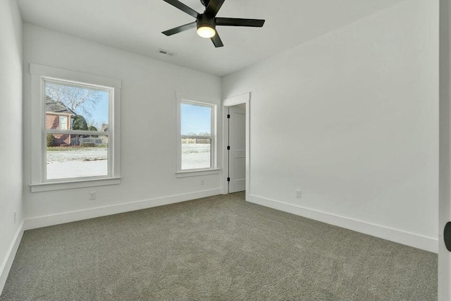 empty room with ceiling fan and carpet