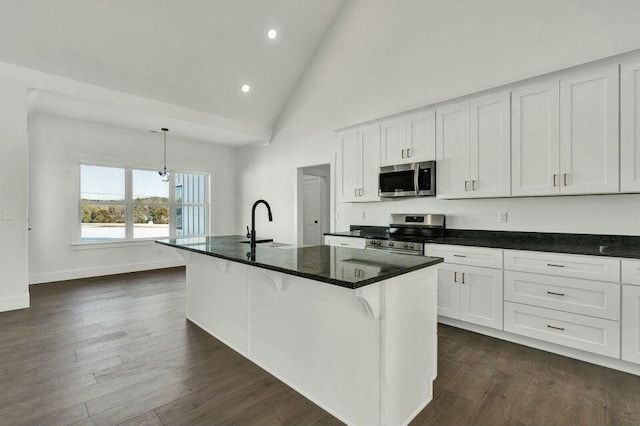 kitchen with a kitchen island with sink, hanging light fixtures, white cabinets, and appliances with stainless steel finishes