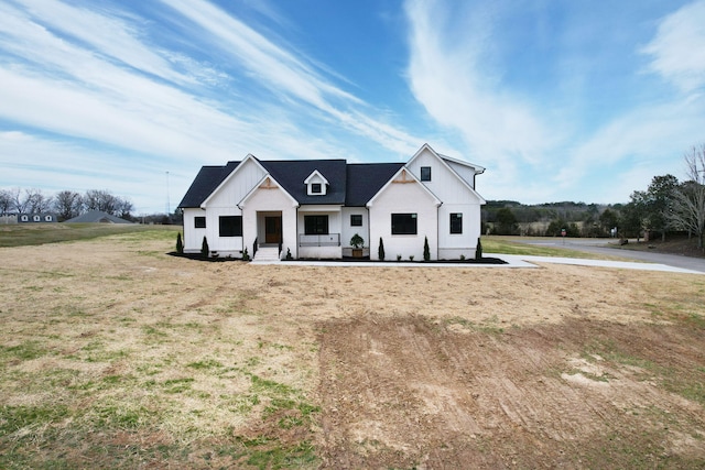 modern farmhouse with a front lawn