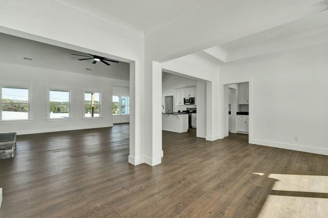 unfurnished living room featuring crown molding, ceiling fan, and dark hardwood / wood-style floors