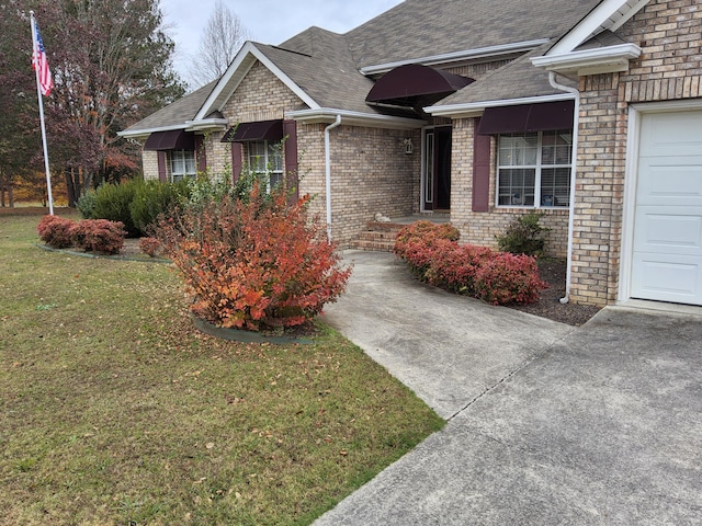 view of front of property with a front yard and a garage