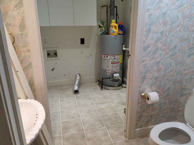 bathroom with tile patterned floors, toilet, and water heater