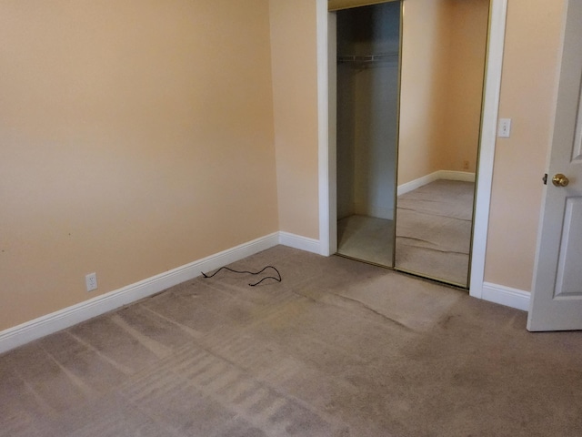 unfurnished bedroom with carpet and a closet