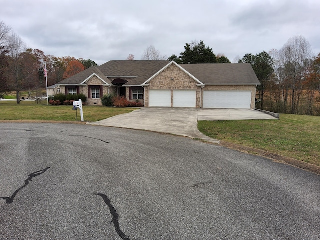 single story home with a garage and a front yard