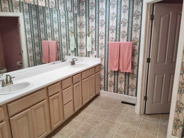 bathroom with tile patterned floors, vanity, and toilet