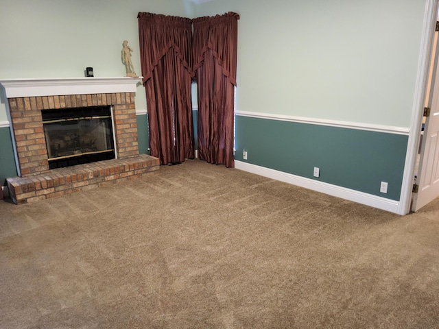 unfurnished living room featuring a fireplace and carpet floors