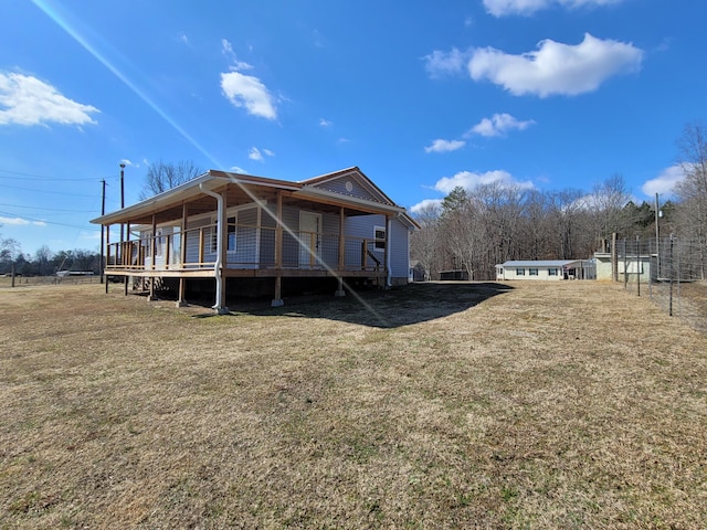 rear view of property with a lawn and a deck