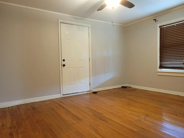 empty room featuring hardwood / wood-style floors, crown molding, and ceiling fan