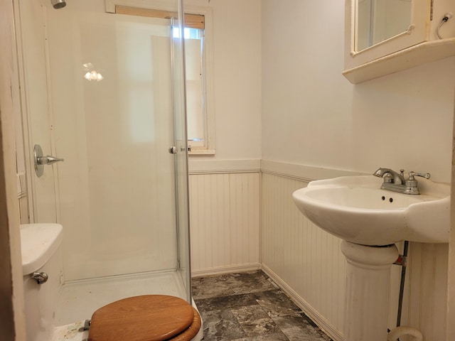 bathroom with walk in shower and toilet